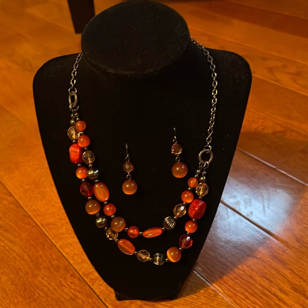 Black chain necklace with amber, red, black and orange beads.